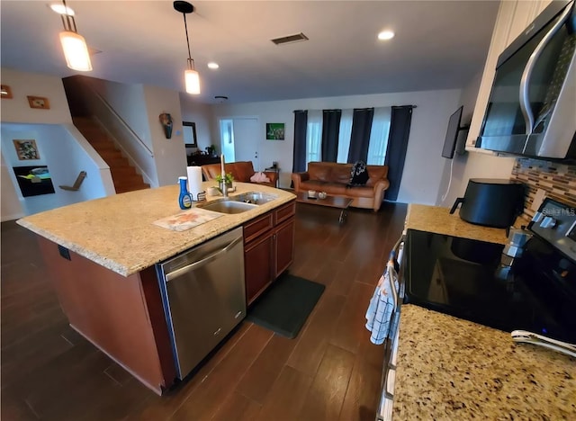 2014 Nancy Ave, Lutz, FL 33548 - kitchen with stainless steel appliances, open floor plan, dark wood-style floors, decorative light fixtures, and recessed lighting