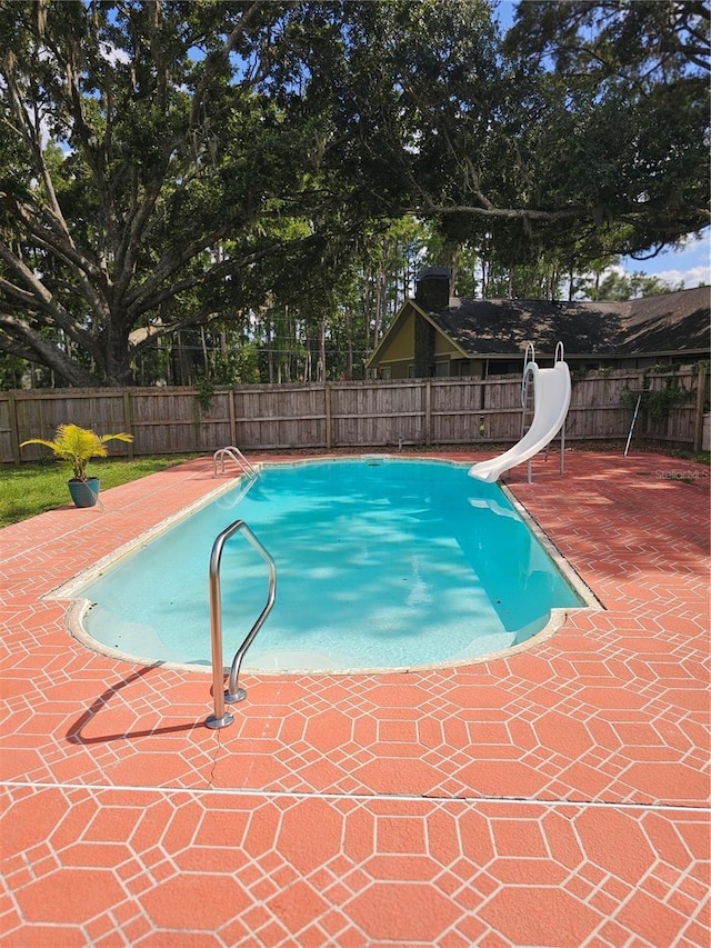 2014 Nancy Ave, Lutz, FL 33548 - view of pool featuring a water slide, a fenced backyard, and a patio area