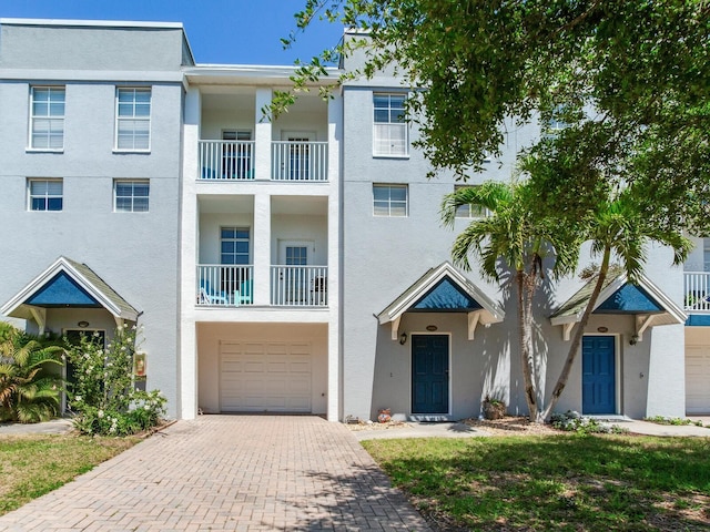4503 Legacy Park Dr, Tampa, FL 33611 - townhome / multi-family property with decorative driveway, an attached garage, and stucco siding