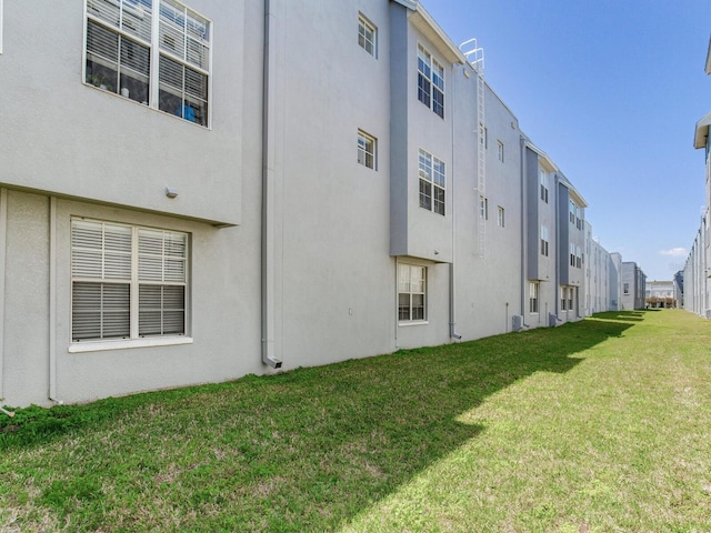 4503 Legacy Park Dr, Tampa, FL 33611 - rear view of property with a lawn and stucco siding