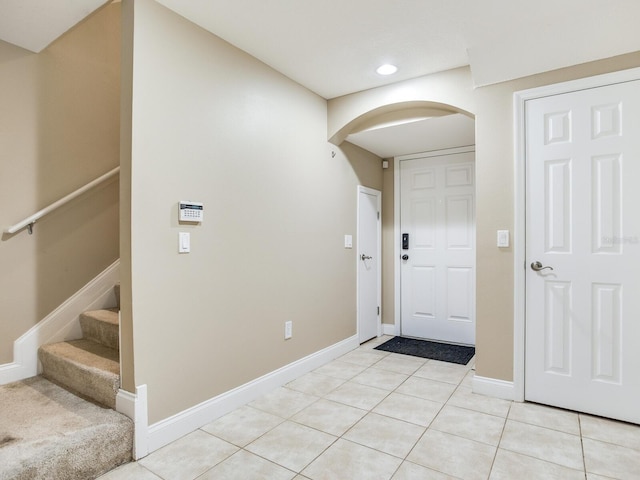 4503 Legacy Park Dr, Tampa, FL 33611 - entryway featuring arched walkways, light tile patterned floors, recessed lighting, and stairway