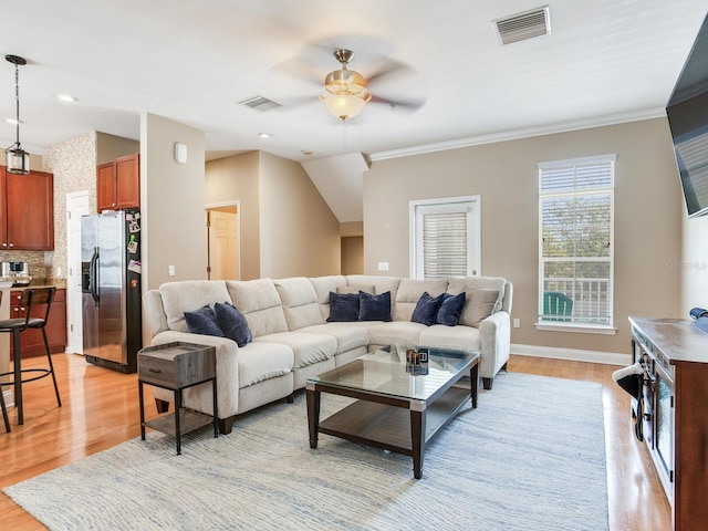 4503 Legacy Park Dr, Tampa, FL 33611 - living area featuring a ceiling fan, ornamental molding, and light wood-style flooring