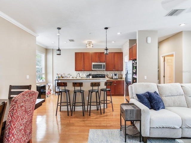 4503 Legacy Park Dr, Tampa, FL 33611 - living room with ornamental molding, light wood-type flooring, and recessed lighting