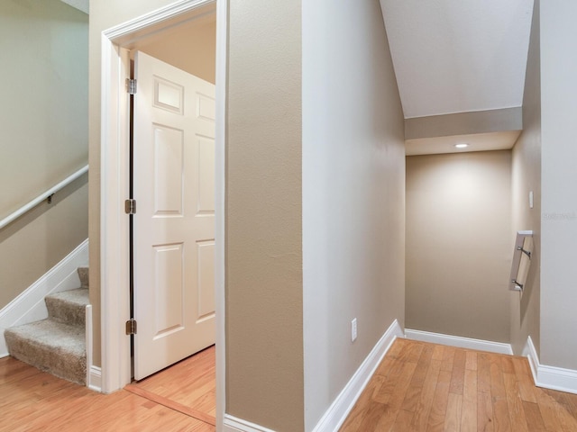 4503 Legacy Park Dr, Tampa, FL 33611 - corridor featuring light wood-style flooring, vaulted ceiling, and stairs