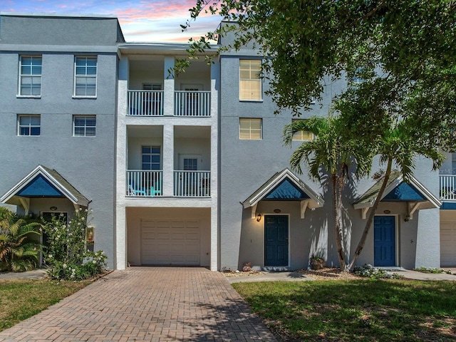 4503 Legacy Park Dr, Tampa, FL 33611 - multi unit property featuring decorative driveway, a garage, and stucco siding