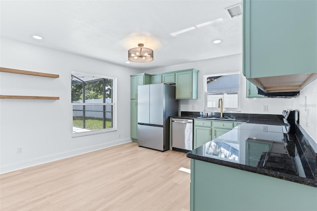 12106 Clearbrook Ct, Riverview, FL 33569 - kitchen featuring stainless steel appliances, green cabinetry, light wood-style floors, recessed lighting, and a chandelier