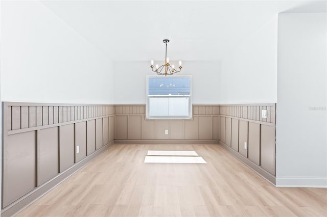 12106 Clearbrook Ct, Riverview, FL 33569 - unfurnished dining area with a chandelier, wood finished floors, and wainscoting