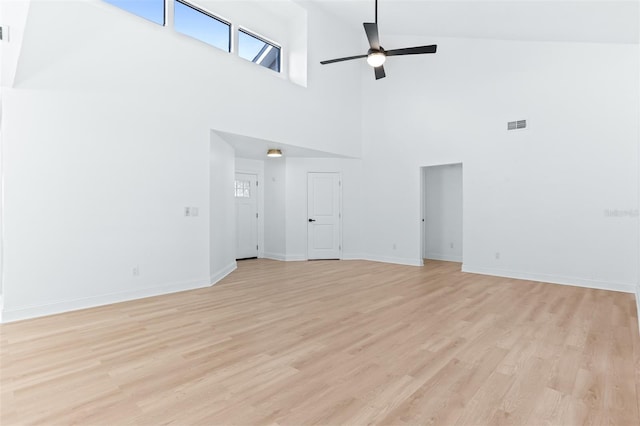 12106 Clearbrook Ct, Riverview, FL 33569 - empty room with a high ceiling, a ceiling fan, and light wood-type flooring