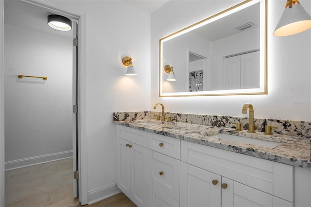 12106 Clearbrook Ct, Riverview, FL 33569 - bathroom featuring double vanity and baseboards