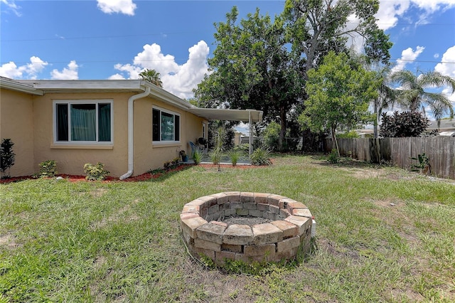 3707 Cambridge St, New Port Richey, FL 34652 - fenced backyard with an outdoor fire pit
