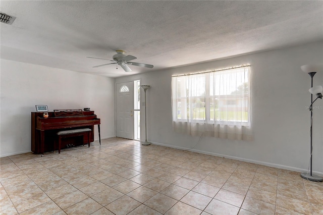 3707 Cambridge St, New Port Richey, FL 34652 - entryway featuring a ceiling fan, light tile patterned flooring, and a textured ceiling