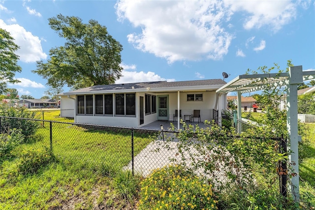 8851 SW 116th Street Rd, Ocala, FL 34481 - back of house with a sunroom, a patio area, and a fenced backyard