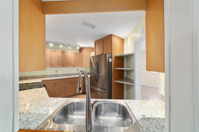 8851 SW 116th Street Rd, Ocala, FL 34481 - kitchen with freestanding refrigerator, light countertops, electric range, brown cabinetry, and light tile patterned flooring
