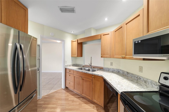 8851 SW 116th Street Rd, Ocala, FL 34481 - kitchen featuring black appliances, light wood finished floors, light stone counters, and recessed lighting