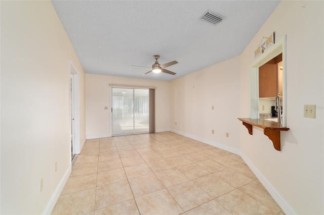 8851 SW 116th Street Rd, Ocala, FL 34481 - spare room with ceiling fan, light tile patterned floors, and a textured ceiling