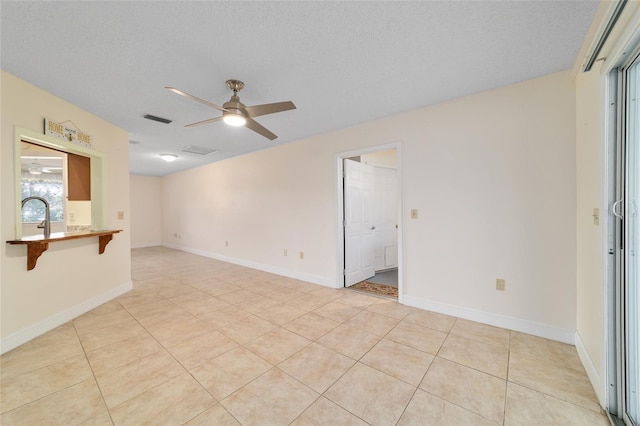 8851 SW 116th Street Rd, Ocala, FL 34481 - unfurnished living room with a ceiling fan, light tile patterned floors, and a textured ceiling