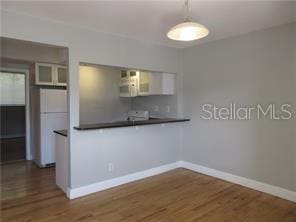 1301 S Howard Ave Unit C4, Tampa, FL 33606 - kitchen with white appliances, dark countertops, and wood finished floors