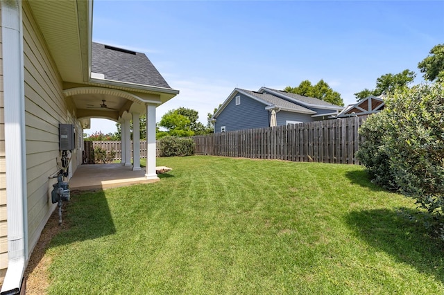 16609 NW 166th Dr, Alachua, FL 32615 - fenced backyard with a ceiling fan and a patio area