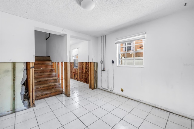 340 Bay Plz, Treasure Island, FL 33706 - spare room featuring a textured ceiling and stairs