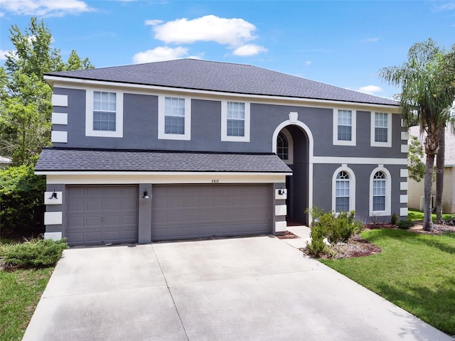 2812 Windcrest Oaks Ct, Valrico, FL 33594 - view of front facade with an attached garage, driveway, a front lawn, and stucco siding