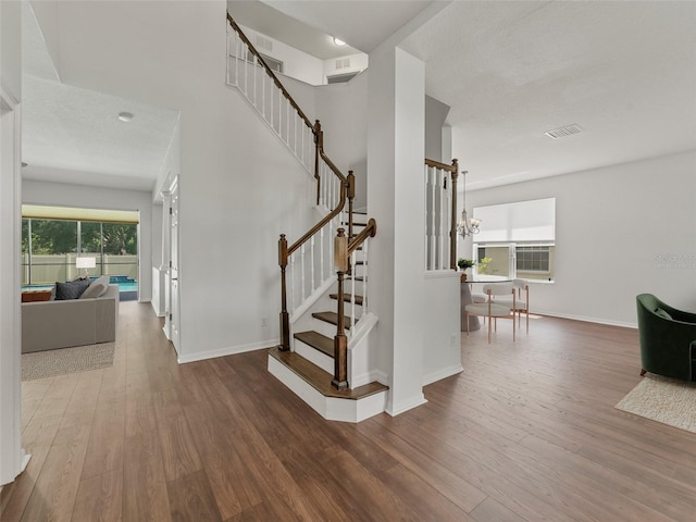 2812 Windcrest Oaks Ct, Valrico, FL 33594 - stairway featuring wood finished floors and a chandelier