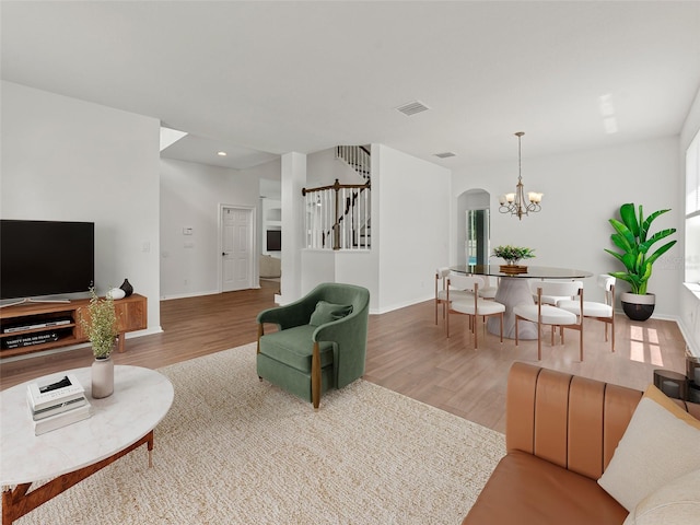 2812 Windcrest Oaks Ct, Valrico, FL 33594 - living area with stairs, wood finished floors, arched walkways, a chandelier, and recessed lighting