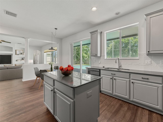 2812 Windcrest Oaks Ct, Valrico, FL 33594 - kitchen with gray cabinets, decorative columns, open floor plan, dishwasher, and a kitchen island