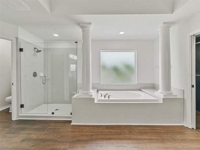 2812 Windcrest Oaks Ct, Valrico, FL 33594 - full bathroom featuring decorative columns, a bath, a stall shower, wood finished floors, and recessed lighting