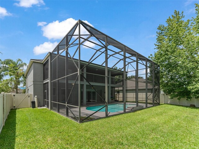 2812 Windcrest Oaks Ct, Valrico, FL 33594 - back of property featuring a fenced backyard, a patio area, glass enclosure, and a gate
