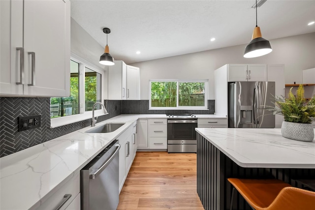 4639 Cabbage Palm Dr, Valrico, FL 33596 - kitchen featuring appliances with stainless steel finishes, plenty of natural light, decorative backsplash, white cabinets, and recessed lighting
