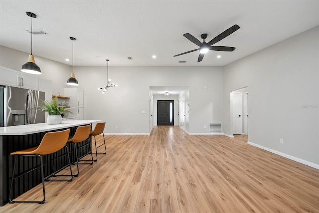 4639 Cabbage Palm Dr, Valrico, FL 33596 - kitchen featuring ceiling fan, light wood-type flooring, light countertops, a breakfast bar area, and recessed lighting