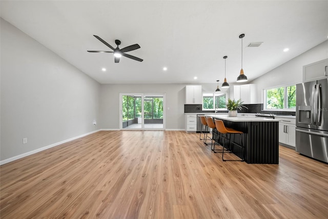 4639 Cabbage Palm Dr, Valrico, FL 33596 - kitchen with stainless steel appliances, a kitchen bar, plenty of natural light, a kitchen island, and recessed lighting