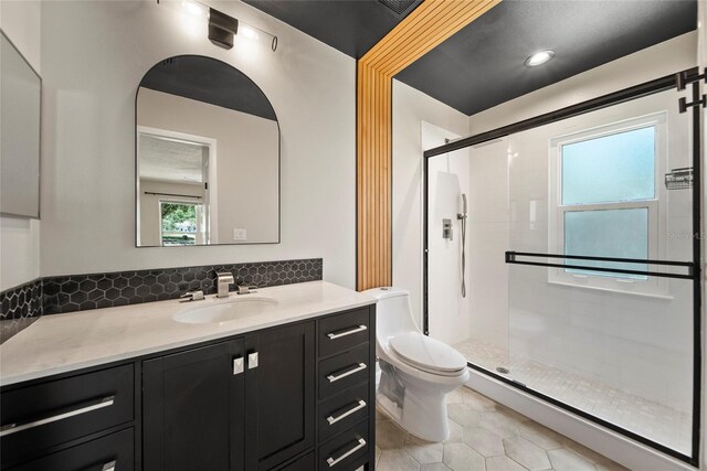 4639 Cabbage Palm Dr, Valrico, FL 33596 - bathroom featuring a stall shower, vanity, tile patterned flooring, and backsplash