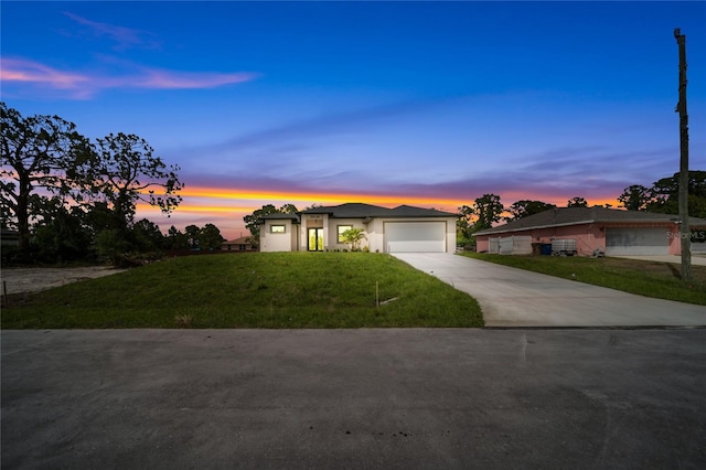 2606 34th St SW, Lehigh Acres, FL 33976 - view of front of property with driveway, a garage, a front lawn, and stucco siding