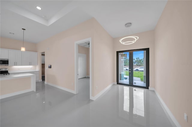 2606 34th St SW, Lehigh Acres, FL 33976 - kitchen with stainless steel microwave, white cabinets, decorative light fixtures, range, and recessed lighting