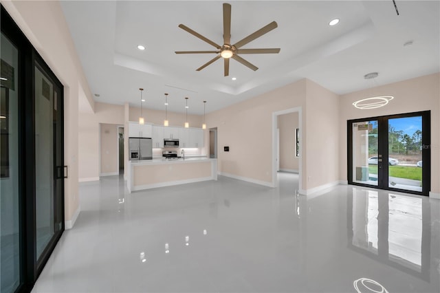 2606 34th St SW, Lehigh Acres, FL 33976 - unfurnished living room featuring a raised ceiling, recessed lighting, a ceiling fan, and light tile patterned floors