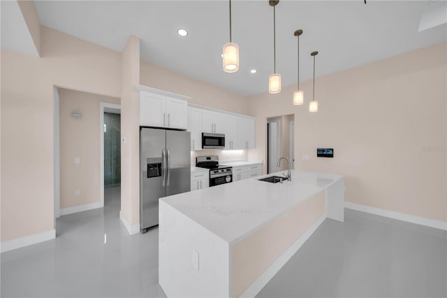 2606 34th St SW, Lehigh Acres, FL 33976 - kitchen featuring stainless steel appliances, white cabinetry, decorative light fixtures, a center island with sink, and recessed lighting