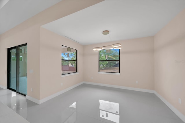 2606 34th St SW, Lehigh Acres, FL 33976 - tiled spare room featuring baseboards