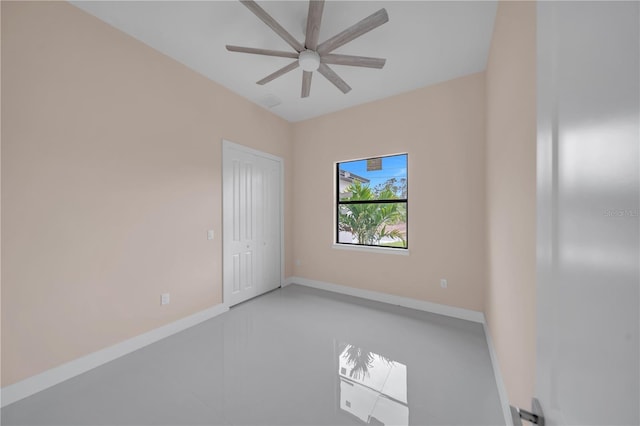 2606 34th St SW, Lehigh Acres, FL 33976 - spare room featuring a ceiling fan and baseboards