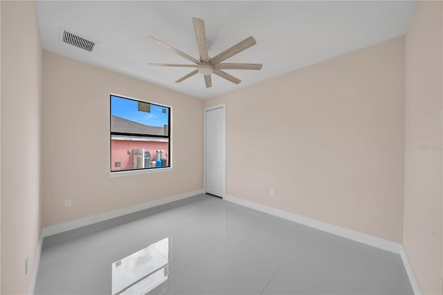 2606 34th St SW, Lehigh Acres, FL 33976 - spare room featuring ceiling fan and baseboards