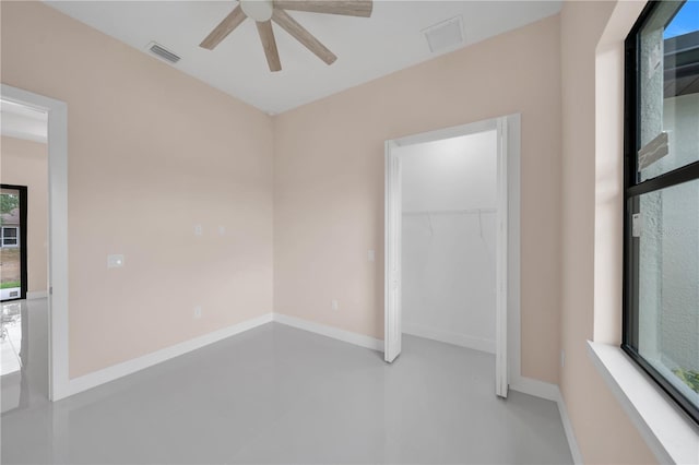 2606 34th St SW, Lehigh Acres, FL 33976 - unfurnished bedroom featuring a closet and ceiling fan