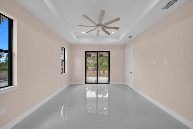 2606 34th St SW, Lehigh Acres, FL 33976 - unfurnished room with ceiling fan, a tray ceiling, recessed lighting, and tile patterned flooring