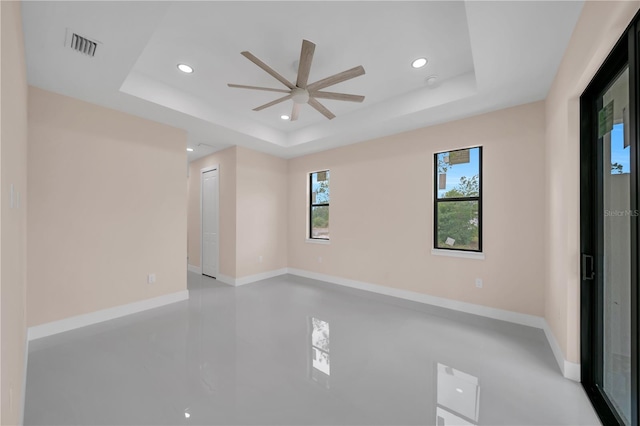 2606 34th St SW, Lehigh Acres, FL 33976 - spare room featuring a ceiling fan, a raised ceiling, and recessed lighting