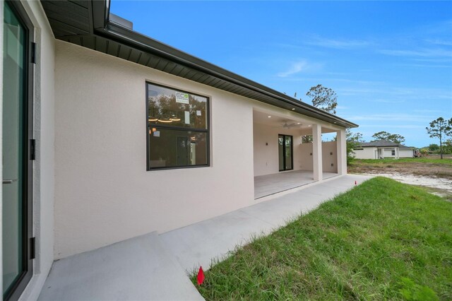 2606 34th St SW, Lehigh Acres, FL 33976 - view of green lawn with a patio area