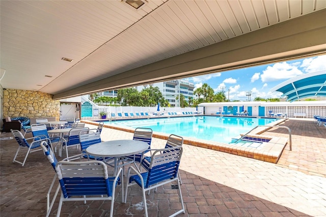 6020 Midnight Pass Rd Unit 49, Sarasota, FL 34242 - community pool with a patio and outdoor dining space