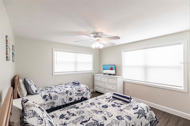 6020 Midnight Pass Rd Unit 49, Sarasota, FL 34242 - bedroom with dark wood-style flooring and a ceiling fan