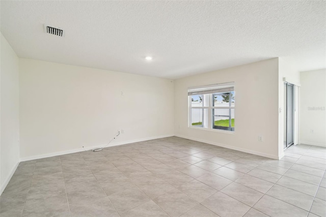 4119 Autumn Amber Dr, Spring Hill, FL 34609 - spare room with a textured ceiling, light tile patterned floors, and recessed lighting