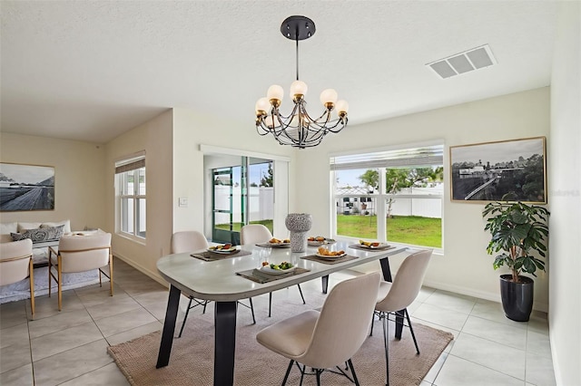 4119 Autumn Amber Dr, Spring Hill, FL 34609 - dining room with healthy amount of natural light, light tile patterned floors, and a chandelier