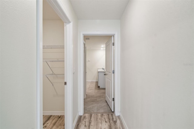 4119 Autumn Amber Dr, Spring Hill, FL 34609 - hall featuring light wood-style floors and baseboards