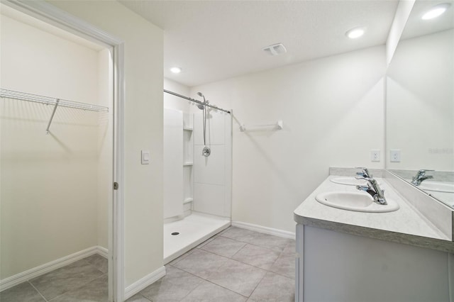 4119 Autumn Amber Dr, Spring Hill, FL 34609 - full bathroom featuring a walk in closet, double vanity, tile patterned floors, a walk in shower, and recessed lighting